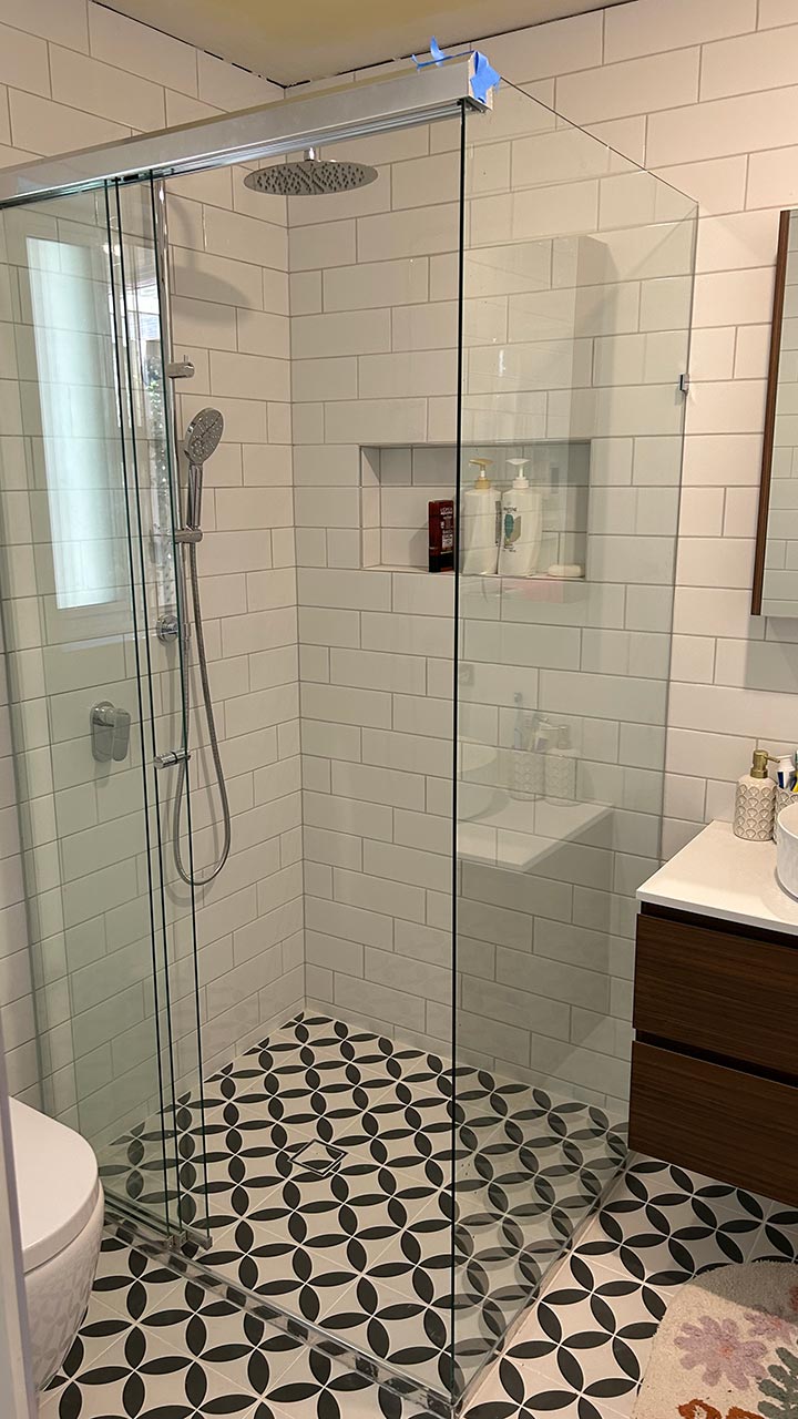 Frameless shower screen with fixed glass panel by Thomo's Home Improvements Canberra
