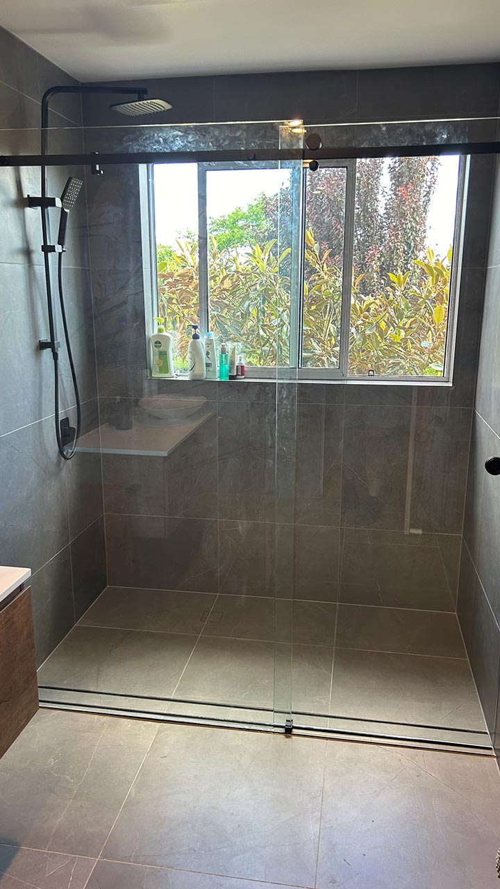 Semi-frameless shower screen with pivot door by Thomo's Home Improvements Queanbeyan