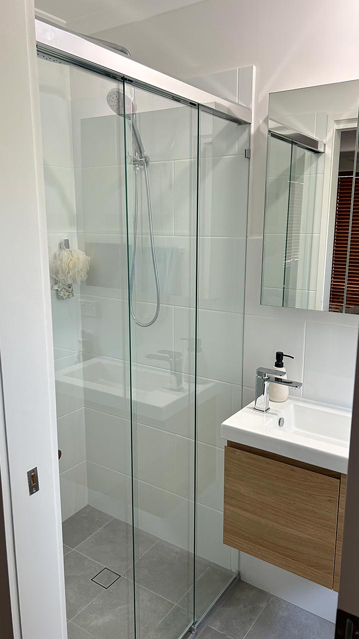 Frameless glass shower screen with chrome fittings by Thomo's Home Improvements Canberra