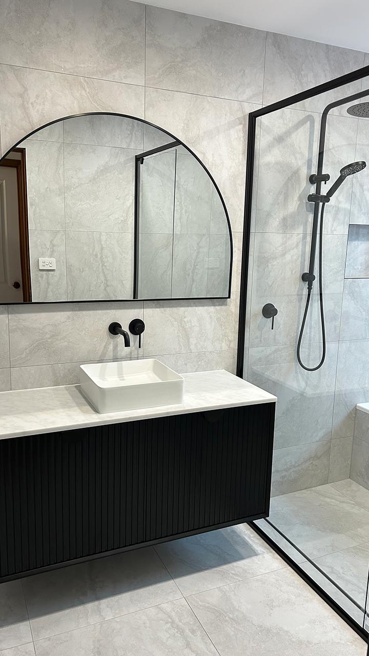Semi-frameless corner shower screen with pivot door by Thomo's Home Improvements