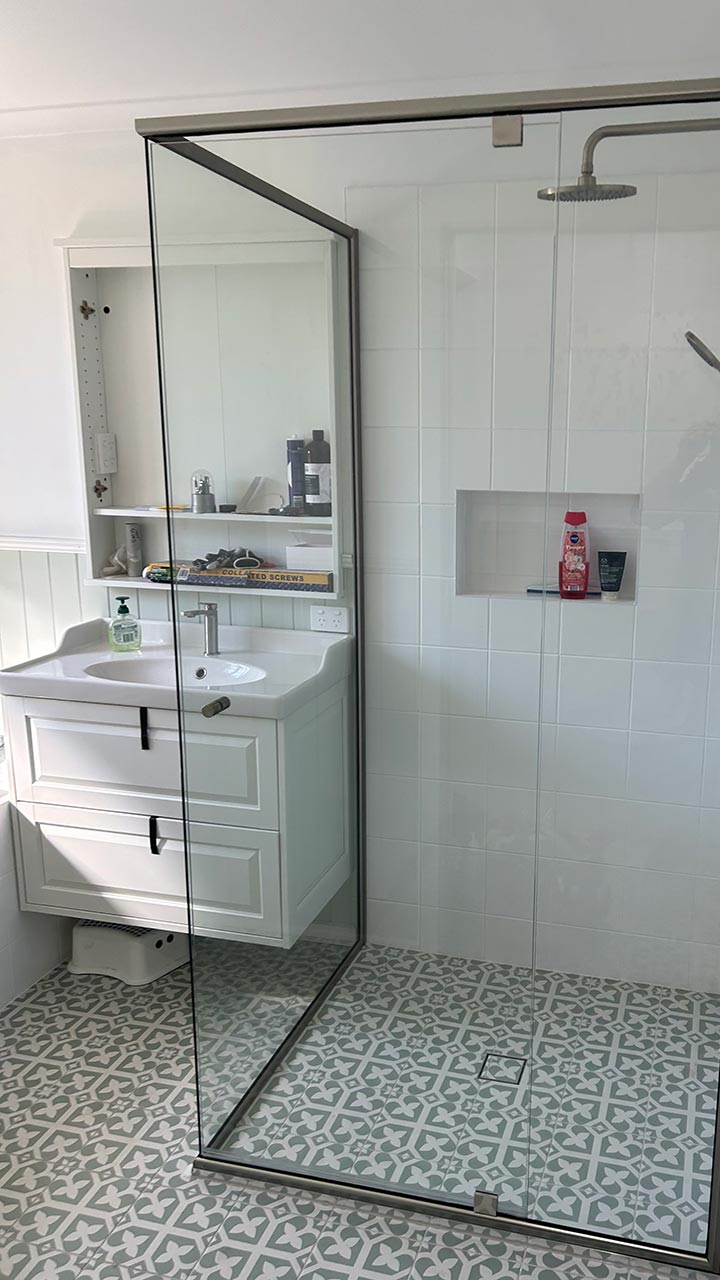 Frameless glass shower screen with wall-to-wall panel by Thomo's Home Improvements