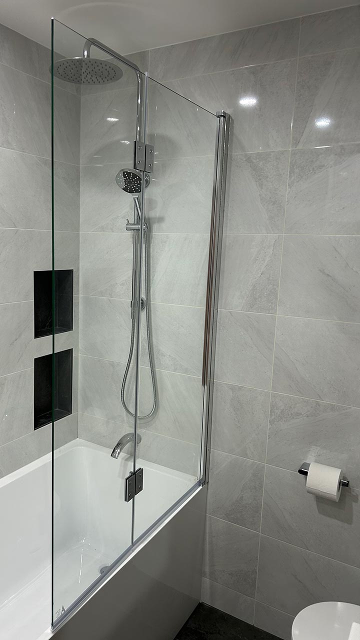Semi-frameless shower screen with polished chrome fixtures by Thomo's Home Improvements