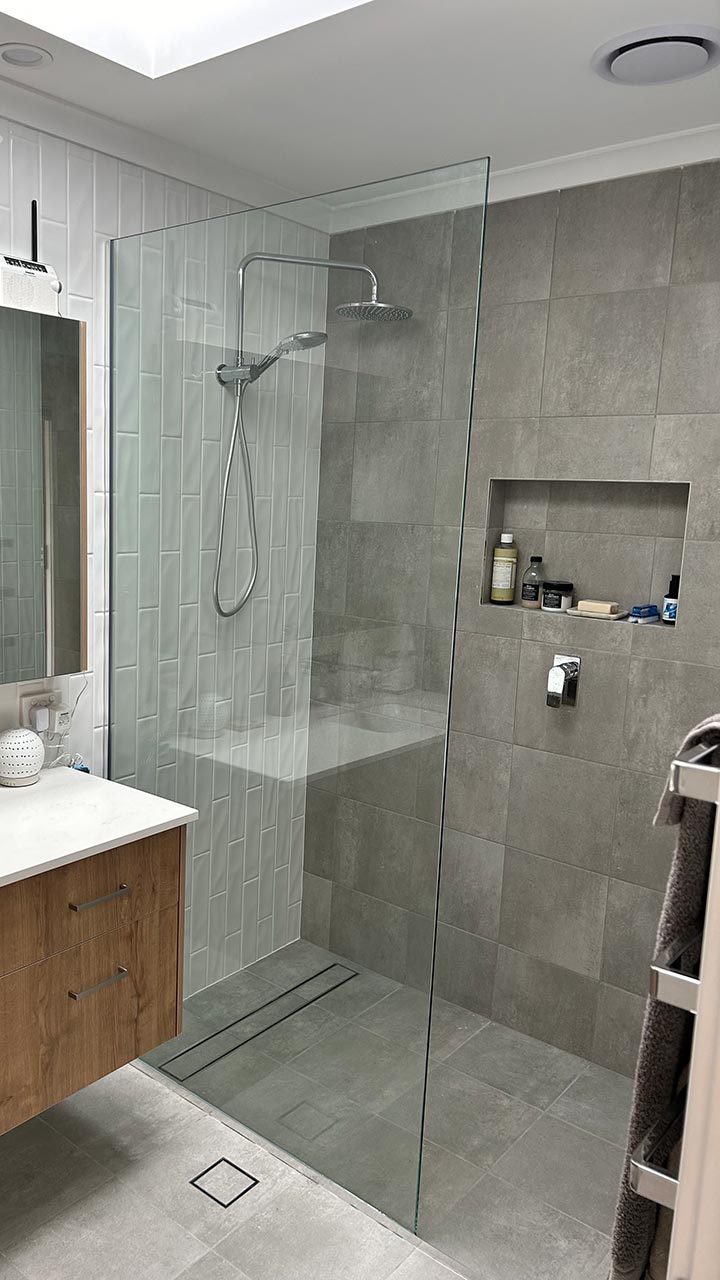 Framed shower screen with frosted glass door by Thomo's Home Improvements Canberra
