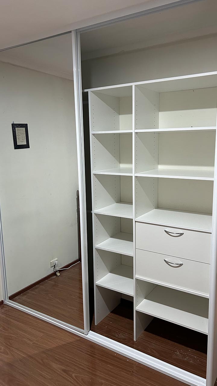 Custom hallway cupboard with shelving and hanging space by Thomo's Home Improvements Canberra