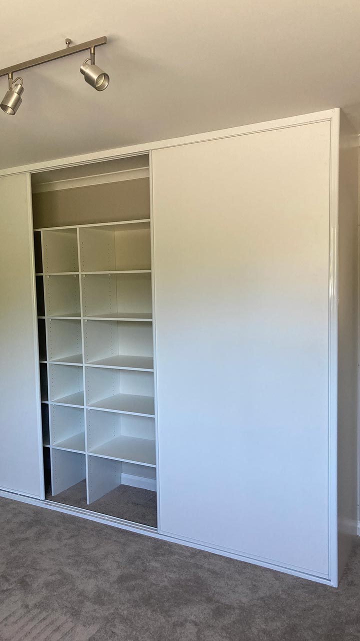 Custom wardrobe with shelving, drawers and mirrored sliding doors by Thomo's Home Improvements